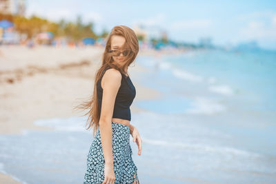 Young woman standing at beach