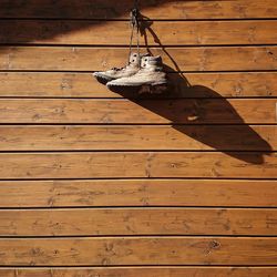 Low angle view of shoes hanging on wall