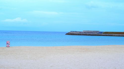 Scenic view of beach and sea against sky