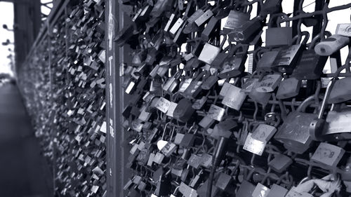 Close-up of padlocks hanging on fence