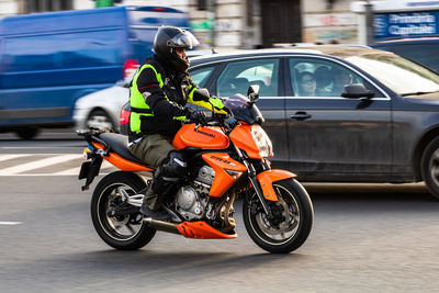 Man riding motorcycle on street in city