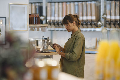 Full length of a woman holding drink