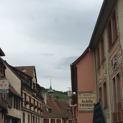 Low angle view of buildings in town against sky