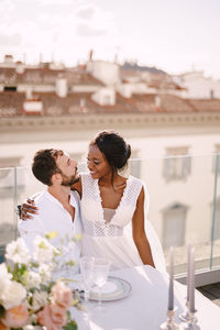 Young couple sitting on table