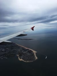 Aerial view of sea against cloudy sky