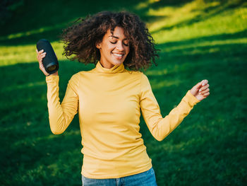 Portrait of a smiling young woman standing outdoors