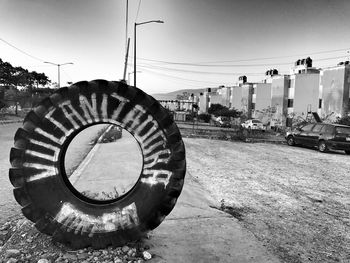 Wheel on beach in city against sky