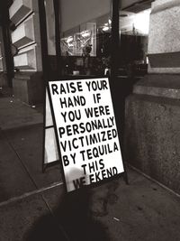 Information sign on street in city at night