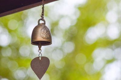 Close-up of chain hanging against blurred background