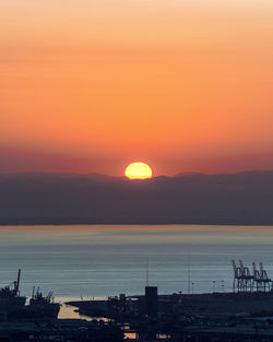 Scenic view of sea against orange sky