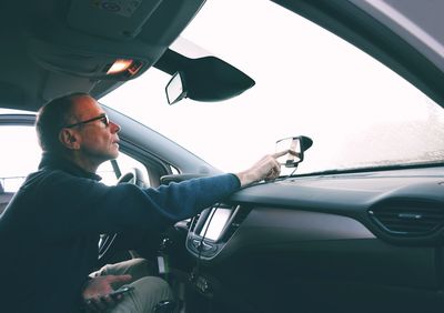 Man using mobile phone in car 