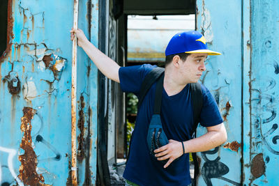 Man standing on doorway of abandoned train