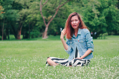 Young woman sitting on grass