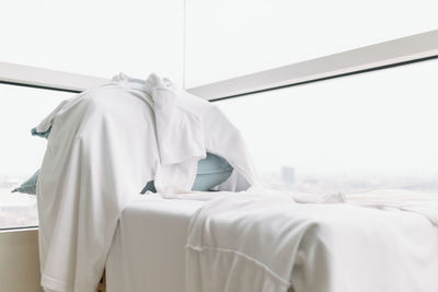 Rear view of man relaxing on bed at home