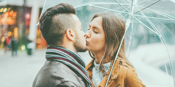 Portrait of young couple kissing outdoors