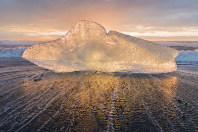 Close-up of frozen sea during winter against sky