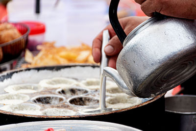 Close-up of man preparing food