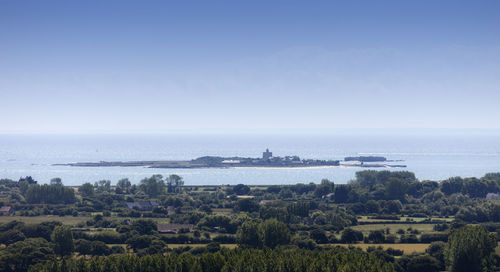 Scenic view of sea against clear blue sky