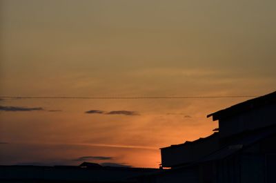 Low angle view of silhouette buildings against sky during sunset