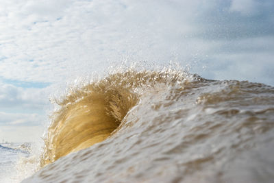 Close-up of sea waves splashing on beach