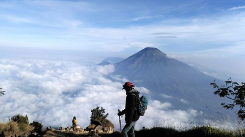 Panoramic view of people riding on mountain against sky