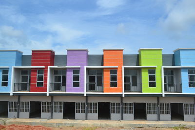 Low angle view of multi colored building against sky