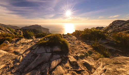 Scenic view of rocks against sky during sunset