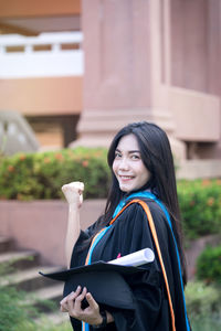 Portrait of a smiling young woman standing outdoors