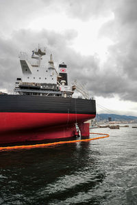 Ship moored on sea against sky