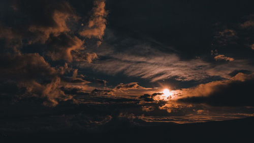 Low angle view of silhouette moon against sky during sunset