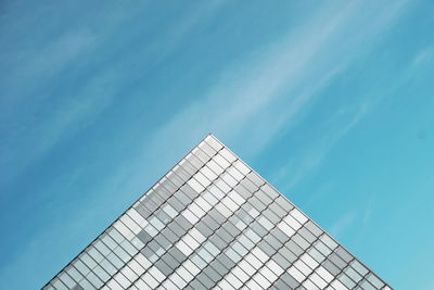 Low angle view of modern building against blue sky