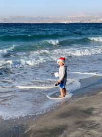 Full length of boy on beach