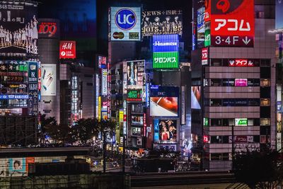 View of neon posters on buildings at night