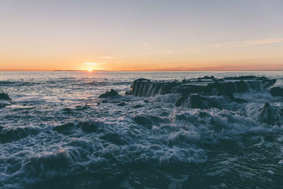 View of calm sea at sunset