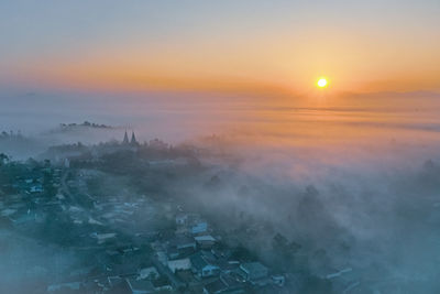 High angle view of buildings against sky during sunset