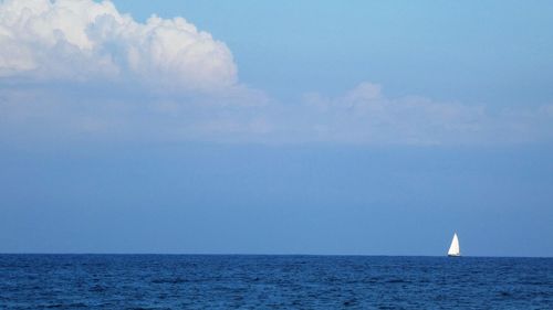 Sailboat in sea against sky