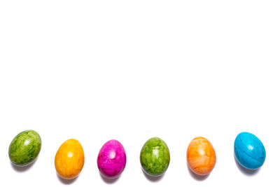 Close-up of multi colored candies against white background