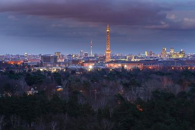 Illuminated city against sky at night