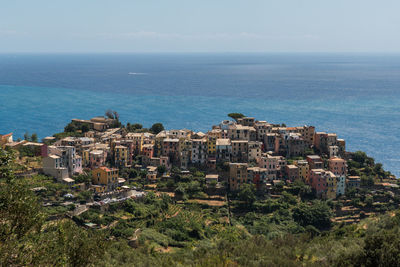 High angle view of townscape by sea against sky