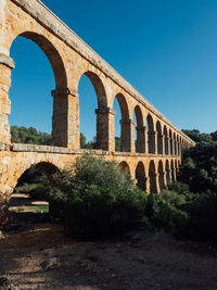 Arch bridge against clear sky