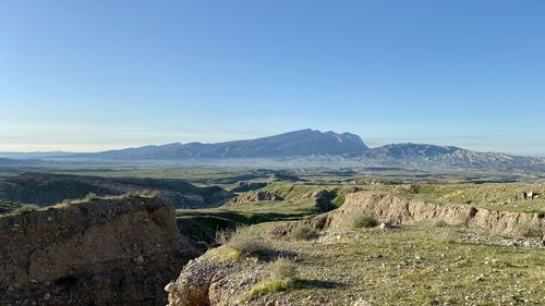 Scenic view of mountains against clear blue sky