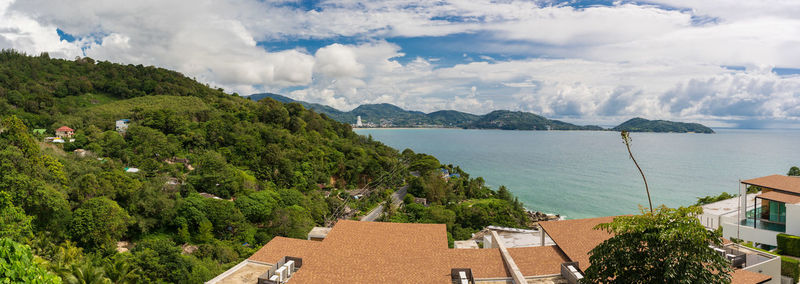 Panoramic view of sea and buildings against sky