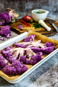 Purple cauliflower in a white baking dish in the oven