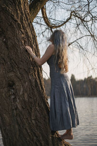Lady climbing willow tree scenic photography