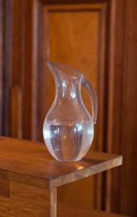 Close-up of glass jug on table