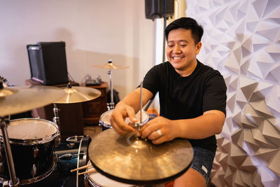 Portrait of man playing drum