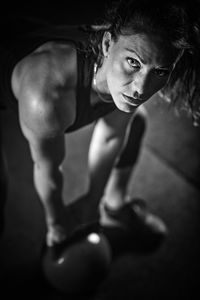 Portrait of young woman exercising at gym