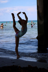 Full length of girl standing at beach