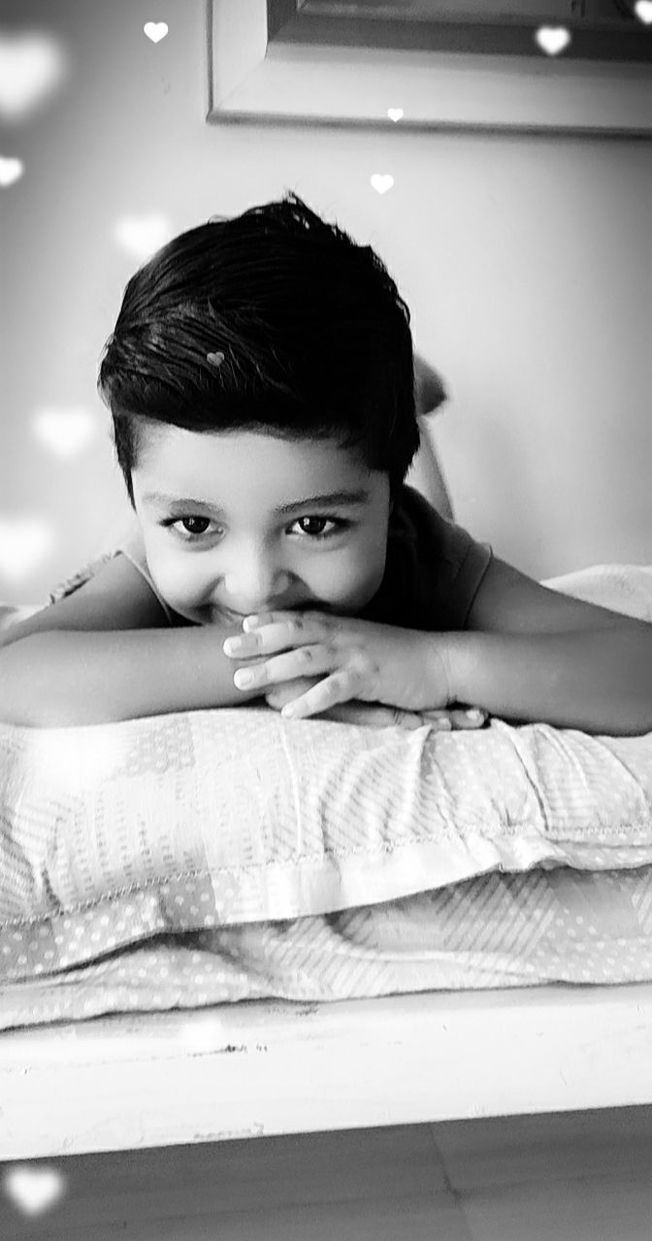 one person, child, white, childhood, black and white, portrait, indoors, black, monochrome photography, women, female, monochrome, person, looking at camera, headshot, lifestyles, relaxation, emotion, domestic room, bed, furniture, lying down, toddler, front view, innocence, baby, photo shoot, cute, home interior, adult, portrait photography, men, looking, leisure activity