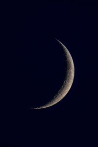 Low angle view of half moon against sky at night